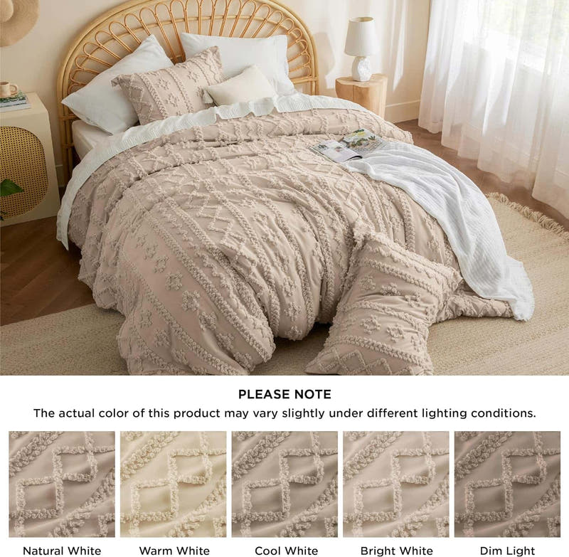 Beige textured comforter on a bed with side tables and curtains in a room.